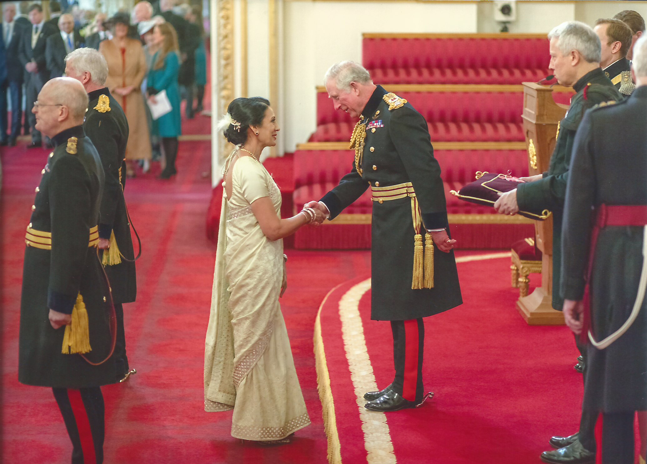 A member of the TLC Lions team, shaking hands with the King